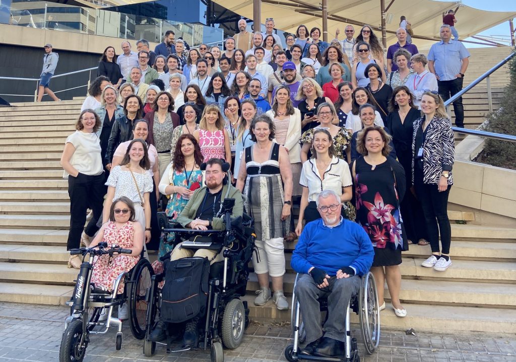 group of people standing on the stairs looking at the camera